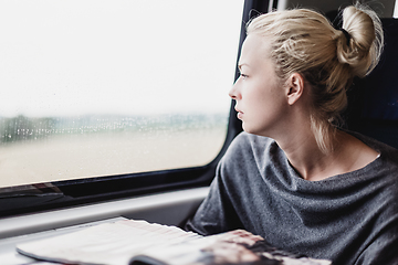 Image showing Lady traveling by train.