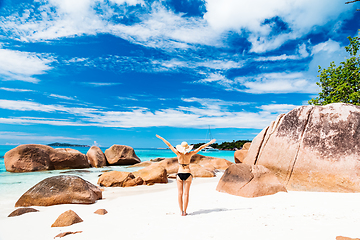 Image showing Happy woman rising hands to the sky on summer vacations on Seychelles