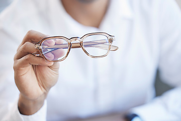Image showing Glasses, optometry and hand of optometrist holding spectacles, eyewear or specs for ophthalmology in an office. Person, eye care and doctor or professional with a vision frame by medical employee
