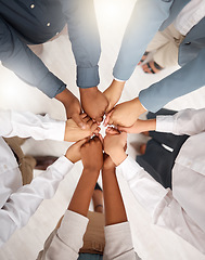 Image showing Teamwork, diversity and group holding hands in circle for support, trust and team building together. Business people in huddle standing in solidarity at office workshop and commitment goal from above