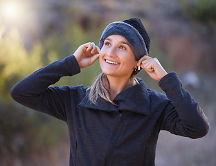 Image showing Music, earphones and woman hiking in nature outdoors for health, exercise and fitness. Winter sports, thinking and happy female hiker streaming radio, podcast or audio after training in forest park.