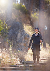 Image showing Earphones, music and woman hiking in nature outdoors for health, exercise and fitness. Winter walking, thinking and happy female hiker streaming radio, podcast or audio while trekking in forest park.