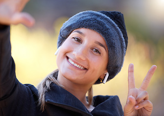 Image showing Portrait, woman and peace sign for support, smile and community outdoor, wellness and cheerful. Face, female and lady with gesture for solidarity, success and motivation with joyful, girl and outside