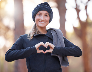 Image showing Portrait, heart hands and smile of woman hiking outdoors for wellness and fitness. Valentines day, love emoji and happy female with hand gesture for romance affection, support or empathy in winter.