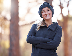 Image showing Portrait, arms crossed and smile of woman hiking outdoors for health and fitness. Winter sports, training and happy, confident and proud female hiker from Canada ready to start exercise in forest.