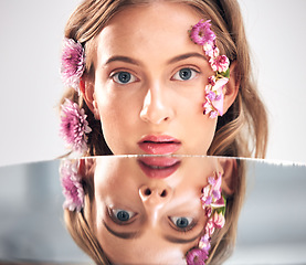 Image showing Beauty face, portrait and mirror woman with flower product, sustainable agriculture and natural skincare reflection. Makeup, nature plant cosmetics and eco friendly girl isolated on studio background