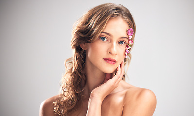 Image showing Beauty flowers, face portrait or woman with floral product, sustainable agriculture and relax natural skincare. Facial makeup, nature plant cosmetic or eco friendly girl isolated on studio background