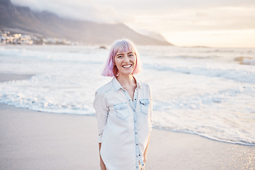 Image showing Sunset, beach and portrait of woman with smile on face, having fun in waves while on holiday in Indonesia. Sea, freedom and travel, happy gen z girl playful on summer ocean vacation on evening walk.