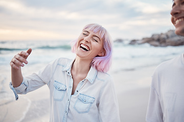 Image showing Happy, beach and vacation with a couple walking on the sand together by the ocean or sea for fun. Smile, humor or joking with a woman and man enjoying a funny joke while bonding on the coast