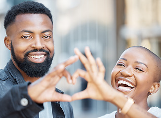 Image showing Love, heart hands and smile with portrait of black couple in city for support, trust and romance. Wellness, happy and connection with face of man and woman with gesture for date, emoji and kindness