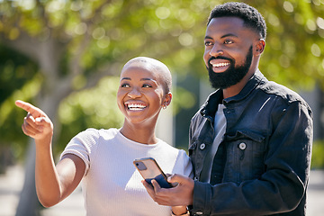 Image showing Happy, phone and pointing with black couple in city for directions, travel and summer date. Smile, love and bonding with man and woman in urban town for technology, social and happiness together