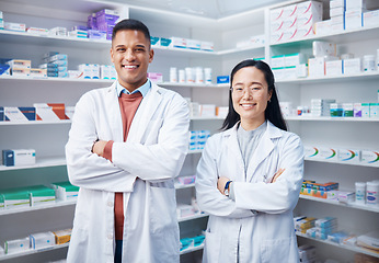 Image showing Portrait, teamwork and pharmacists with arms crossed in pharmacy, drugstore and medicine shop. Healthcare, pharma wellness and happy, proud and confident smile of medical doctors, man and Asian woman