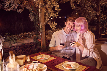 Image showing Couple at dinner, celebration at restaurant with fine dining, wine and food with love and anniversary and young people. Happiness, eating and care in relationship with commitment and partnership