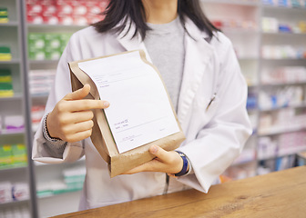 Image showing Prescription, medicine and hands of a pharmacist with a bag for health, medical pills and drugs. Retail, wellness and woman at a pharmacy for service, healthcare advice and showing information