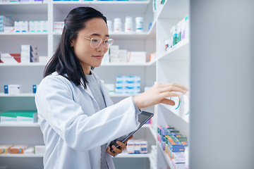 Image showing Tablet, Asian woman and pharmacist stock check in pharmacy for healthcare medicine in drugstore. Medication, technology or young female medical doctor with touchscreen for checking inventory in shop.