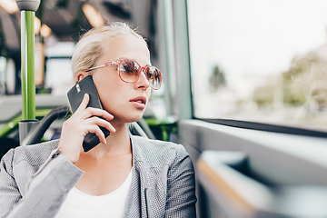 Image showing Blonde business woman traveling by bus.