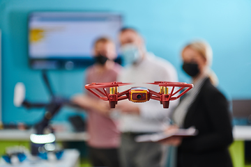 Image showing A group of students working together in a laboratory, dedicated to exploring the aerodynamic capabilities of a drone