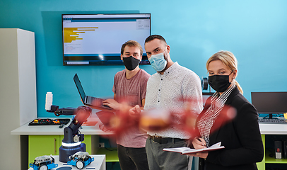 Image showing A group of students working together in a laboratory, dedicated to exploring the aerodynamic capabilities of a drone