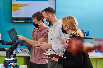 Image showing A group of students working together in a laboratory, dedicated to exploring the aerodynamic capabilities of a drone