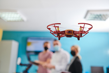 Image showing A group of students working together in a laboratory, dedicated to exploring the aerodynamic capabilities of a drone