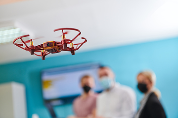 Image showing A group of students working together in a laboratory, dedicated to exploring the aerodynamic capabilities of a drone