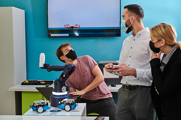 Image showing A group of students working together in a laboratory, dedicated to exploring the aerodynamic capabilities of a drone