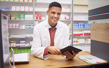 Image showing Pharmacy, smile and portrait of man at counter with tablet in drugstore, customer service and medical advice. Prescription drugs, pharmacist and inventory of pills and medicine at checkout in store.