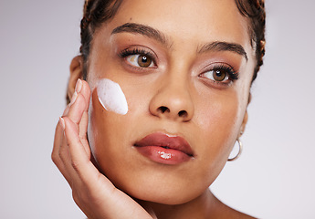 Image showing Black woman, lotion and skincare of a young model with facial mask, moisturizer and wellness. Studio, beauty and female with dermatology, collagen and cosmetic face cream for skin glow and self care