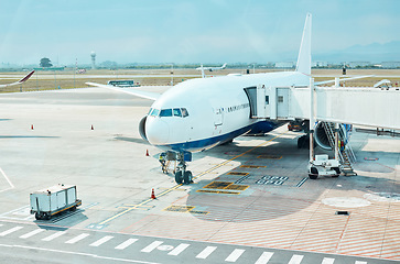 Image showing Airplane, airport and runway near terminal and boarding steps for a flight for travel, logistics or commercial transport. Plane, aircraft and airline vehicle outdoors in Cape Town International