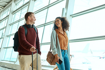 Image showing Travel, love and smile with interracial couple in airport for vacation, tourism and departure. International trip, luggage and holiday with man and black woman walking for flight, journey or airline