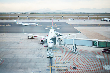 Image showing Travel, departure and airplane on land at the airport for fuel, cargo and boarding people. Aircraft, trip and transportation ready to start traveling and flying in the terminal while on a runway