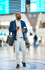 Image showing Black man checking flight schedule with phone and ticket walking in airport terminal, holding passport for business trip. Smile, travel app and happy businessman boarding international destination.