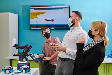 Image showing A group of students working together in a laboratory, dedicated to exploring the aerodynamic capabilities of a drone