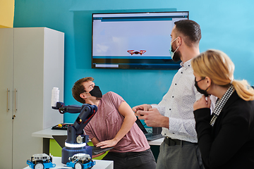 Image showing A group of students working together in a laboratory, dedicated to exploring the aerodynamic capabilities of a drone