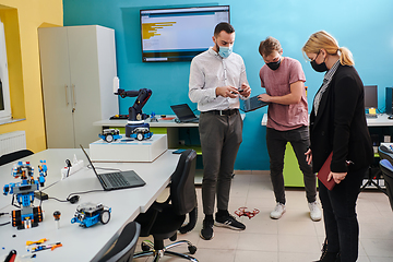 Image showing A group of students working together in a laboratory, dedicated to exploring the aerodynamic capabilities of a drone