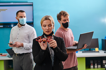 Image showing A group of students working together in a laboratory, dedicated to exploring the aerodynamic capabilities of a drone