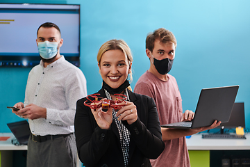 Image showing A group of students working together in a laboratory, dedicated to exploring the aerodynamic capabilities of a drone