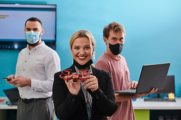 Image showing A group of students working together in a laboratory, dedicated to exploring the aerodynamic capabilities of a drone