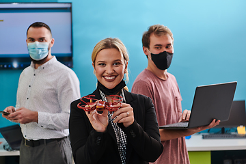 Image showing A group of students working together in a laboratory, dedicated to exploring the aerodynamic capabilities of a drone