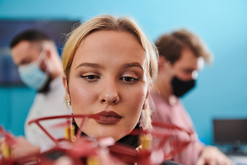 Image showing A group of students working together in a laboratory, dedicated to exploring the aerodynamic capabilities of a drone