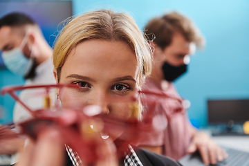 Image showing A group of students working together in a laboratory, dedicated to exploring the aerodynamic capabilities of a drone