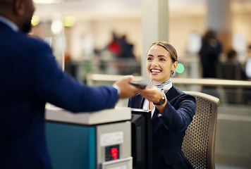 Image showing Woman, airport and service agent with passport helping traveler for check in at terminal counter. Female passenger assistant with smile in travel security or immigration documents for airline control