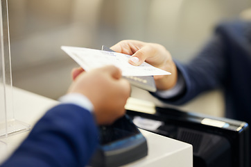 Image showing Hands, airport and service agent with ticket, passport or documents to board plane at terminal counter. Hand of female passenger assistant giving access for travel, security or immigration papers