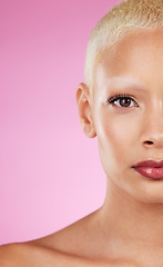 Image showing Beauty, half face and woman in portrait with makeup, skincare glow, eye and healthy skin on pink background. Natural cosmetics, lashes and mockup space, dermatology and cosmetic shine with wellness