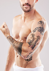 Image showing Body, skin and man with arm tattoo, fitness and muscle with beauty, exercise and flex biceps on studio background. Health, strong and bodybuilder, weightlifting and art with strength and wellness