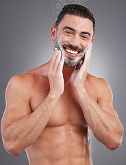 Image showing Soap, beard and portrait of a man in the shower isolated on a grey studio background. Skincare, cleaning and model washing facial hair for grooming, hygiene and morning routine on a backdrop