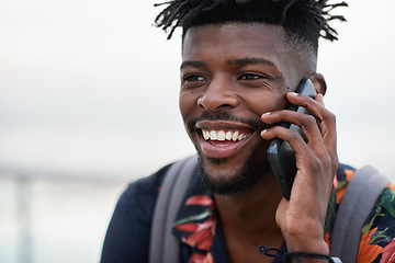 Image showing Phone call, happy and black man with a cellphone for communication in the city while on an adventure. Happiness, smile and African male on a mobile conversation with smartphone in town on a holiday.
