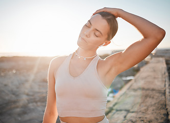 Image showing Beach, fitness or woman stretching neck for exercise running, marathon training and listening to radio, podcast or music. Nature freedom, calm peace or athlete warm up for outdoor performance workout