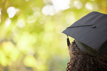 Image showing Graduation cap, trees and back of woman outdoor for education achievement, success and goals with bokeh. Nature, mockup space and female university or college graduate planning future for motivation.