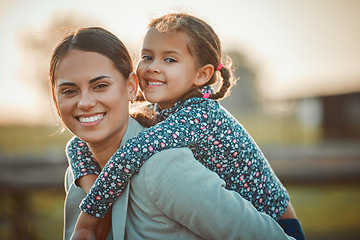 Image showing Mother, happy girl and portrait of piggy back fun and parent care outdoor in equestrian field. Mom smile, child happiness and family in nature with blurred background in summer on holiday in a park